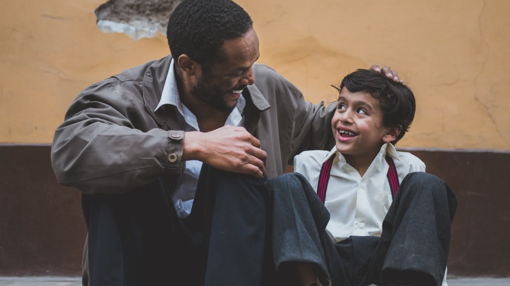 Father holding his son while they are smiling