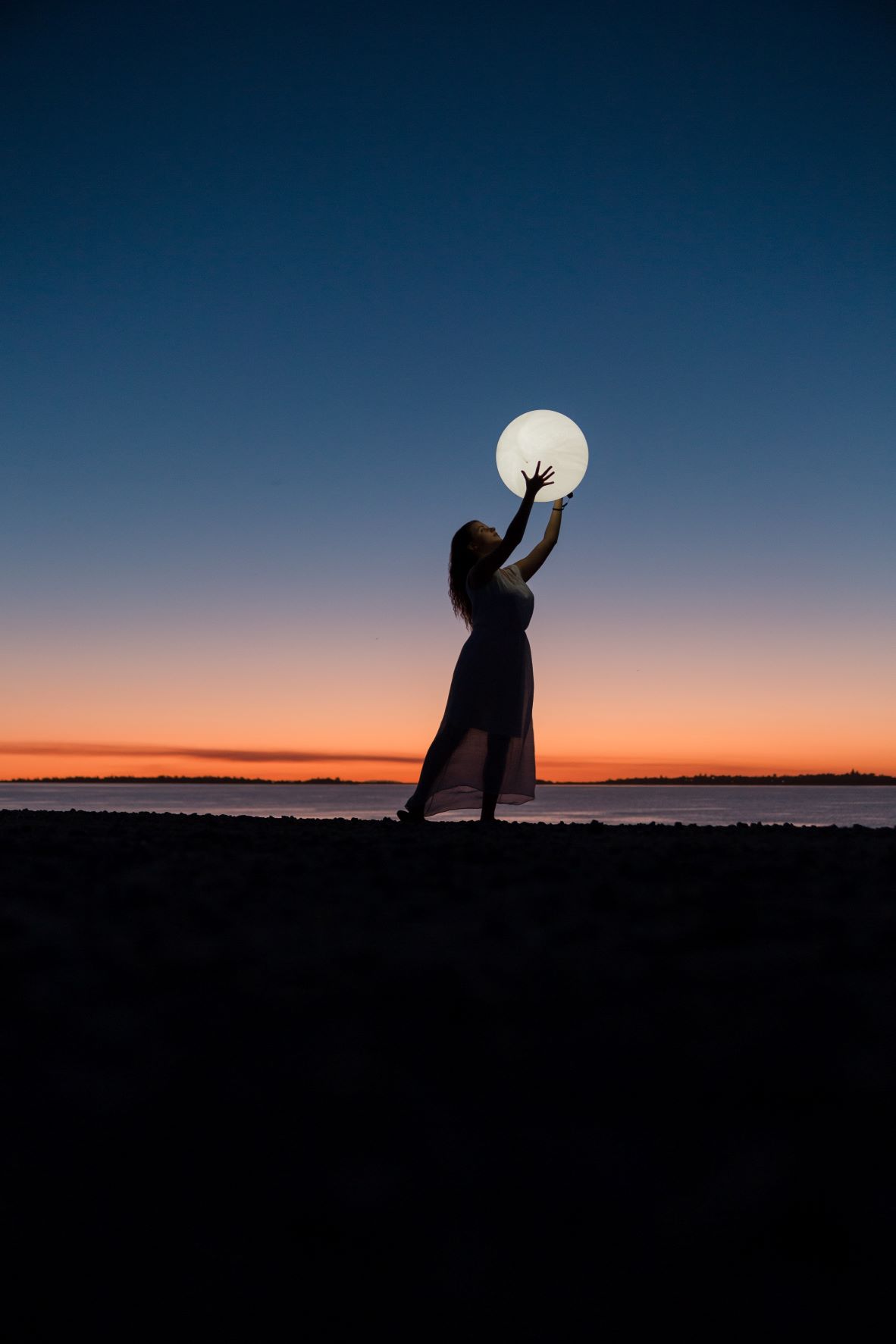 woman "holding" the moon