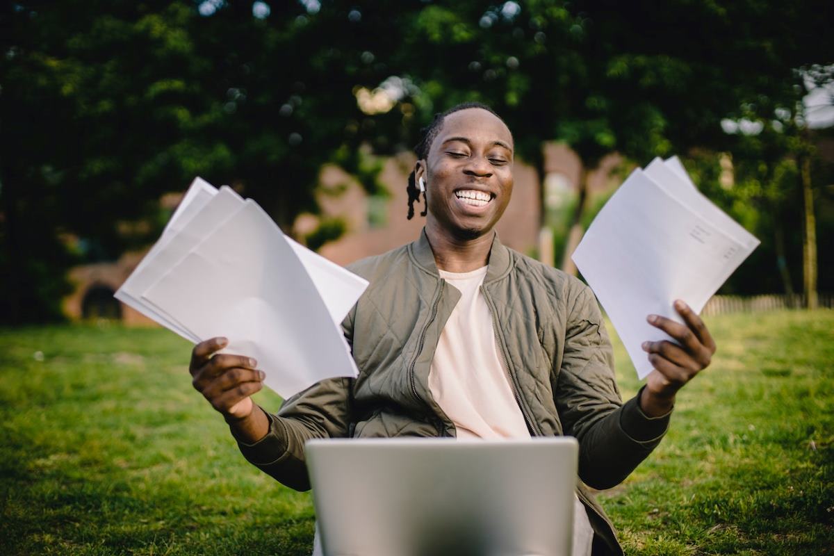 man laughing with stack of paper inspirational autobiographies